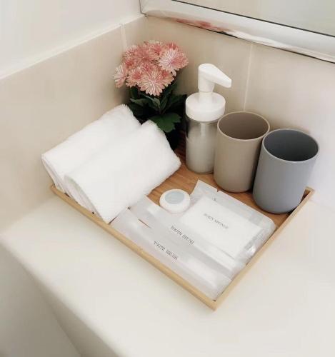 a shelf with a sink and two cups and a flower at Forest Lake best stay in Wacol