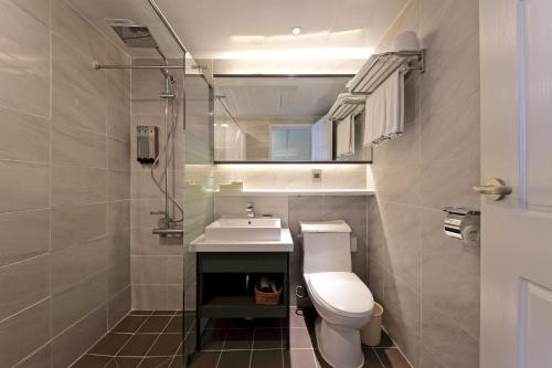 a bathroom with a white toilet and a sink at Benikea Swiss Rosen Hotel in Gyeongju