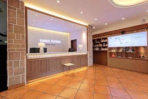 a lobby with a smiley face on the wall at Benikea Swiss Rosen Hotel in Gyeongju