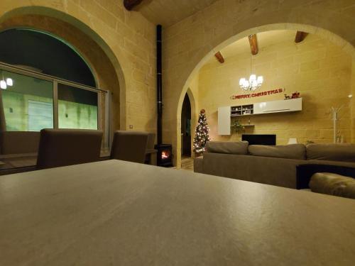 a room with a table and couches and a fireplace at Simar in Qala