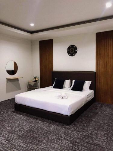 a bedroom with a large bed with white sheets at My home resort - ขนอม นครศรีธรรมราช in Khanom