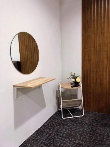 a bathroom with a mirror and a table and a shelf at My home resort - ขนอม นครศรีธรรมราช in Khanom