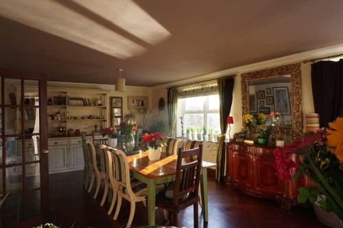 a kitchen with a table and chairs and a dining room at Innis House in Insch
