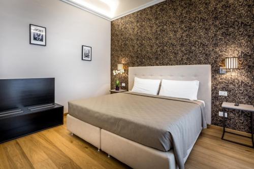a bedroom with a large bed and a large window at Martelli 6 Suite & Apartments in Florence