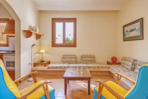 a living room with a couch and a table and chairs at Possessio Sa Barrala Casa del Pages in Campos