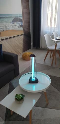 a table with a light on it in a living room at V-Apartments in Ostend