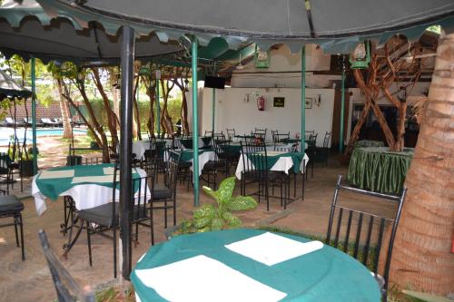 a group of tables and chairs under a tent at Impala Safari Lodge in Voi