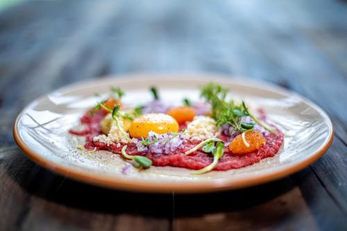 a plate of food on a wooden table at Mountain Lodge in Stöten