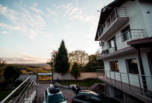 a building with cars parked in a parking lot at Villa Villekulla in Chukovezer