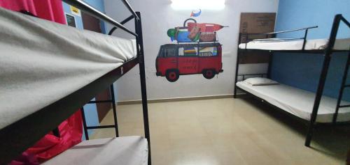 a room with two bunk beds in a dorm at HosteLife Gokarna in Gokarna
