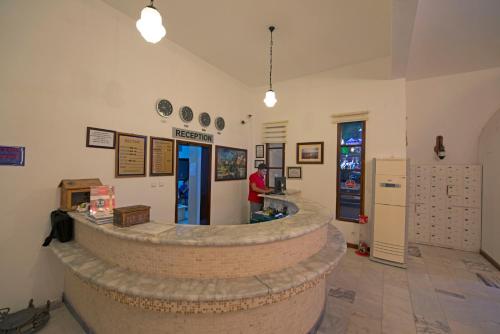 a man is standing in a room with a large stone counter at Sami Beach Hotel- All Inclusive in Gümbet