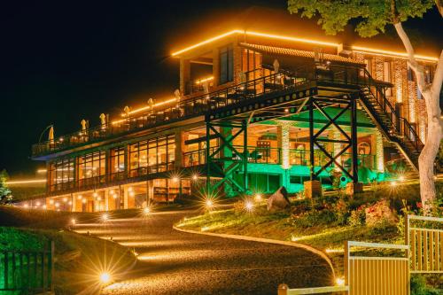 a building at night with lights in front of it at Mtserlebi Resort in K'vishkhet'i