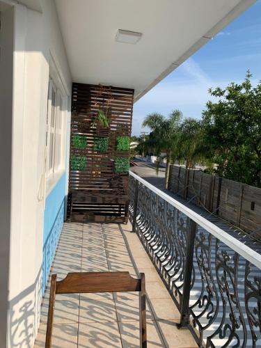 a balcony with a chair on a building at Recanto da Sol in Florianópolis