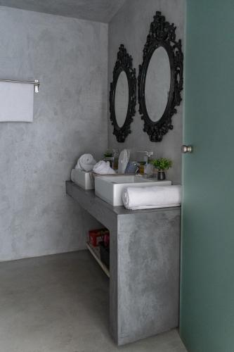 a bathroom with a sink and a mirror on the wall at Sinanis city home in Volos