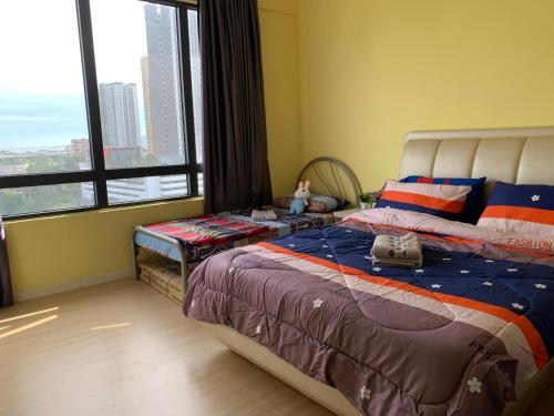 a bedroom with a large bed and a large window at Woodsbury homestay Studio 57 Butterworth in Butterworth