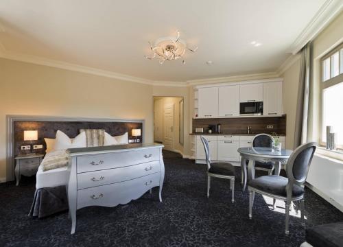 a bedroom with a bed and a desk and a table at Cityappartement am Belvedere in Weimar