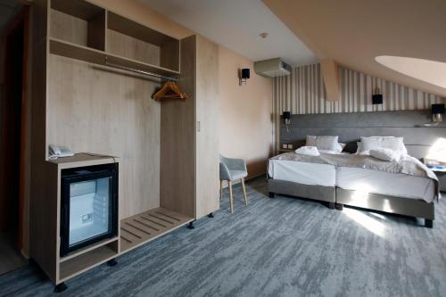 Postel nebo postele na pokoji v ubytování Wellness Hotel Laroba