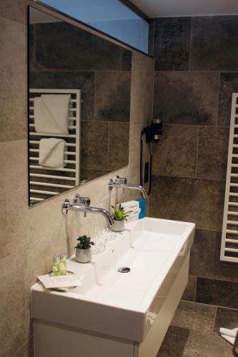a bathroom with a white sink and a mirror at Haus Steffeler in Sankt Anton am Arlberg