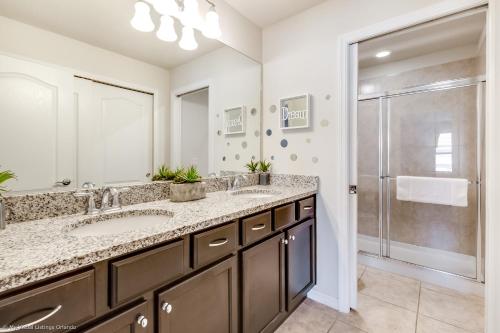 a bathroom with two sinks and a shower at Resort Townhome wPRIVATE Pool & BBQ, near Disney in Kissimmee