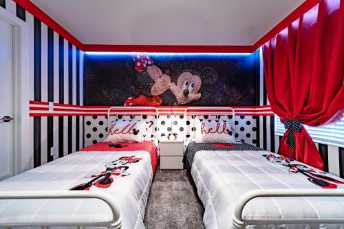 two beds in a room with red and blue curtains at STAR WARS GAME ROOM -Private Pool -FREE Waterpark in Kissimmee
