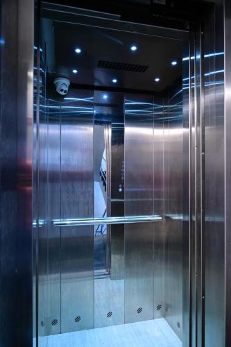 a elevator in a building with stainless steel doors at HOTEL DAKSH in Chinchwad