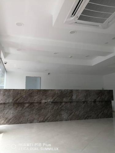 a white room with a counter in the middle at Grand Bagan Hotel in Butterworth
