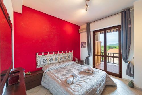 a red bedroom with a bed with a red wall at Alghero Amantiosu Casa Vacanze in Alghero