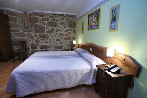 A bed or beds in a room at Hotel Rústico Casa Franco