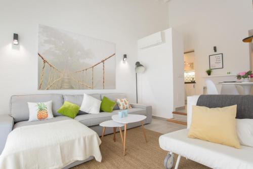 a living room with a couch and a bridge painting on the wall at Apartamento Ferrera Park 624 in Felanitx