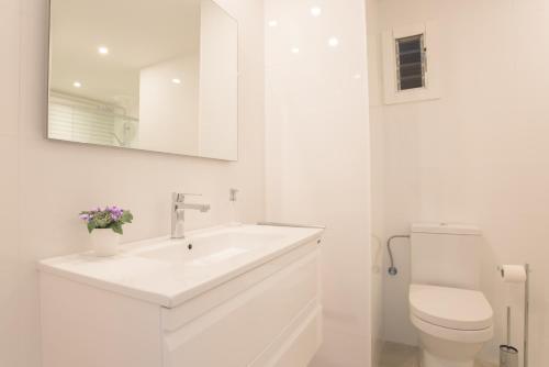 a white bathroom with a sink and a toilet at Apartamento Ferrera Park 624 in Felanitx