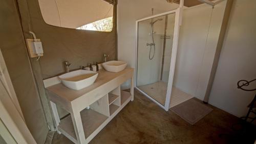 a bathroom with a white sink and a shower at Malansrus in Twyfelfontein