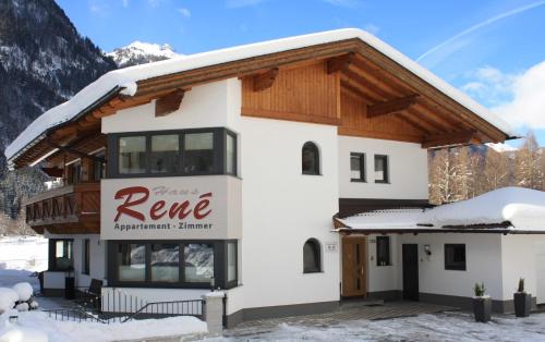 a building with a sign that reads renee apartment summit at Haus Rene in Längenfeld
