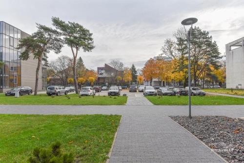 a street with cars parked in a parking lot at Palanga Apartments Near Baltic Sea in Palanga