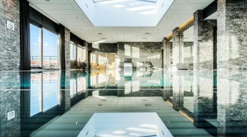 an empty room with a pool in a building at Van der Valk Hotel Dordrecht in Dordrecht