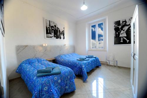 a room with two beds and a table and chairs at La Marina in Ancona