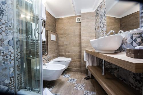 a bathroom with two sinks and a shower and a toilet at Hotel Fellini a Fontana di Trevi in Rome