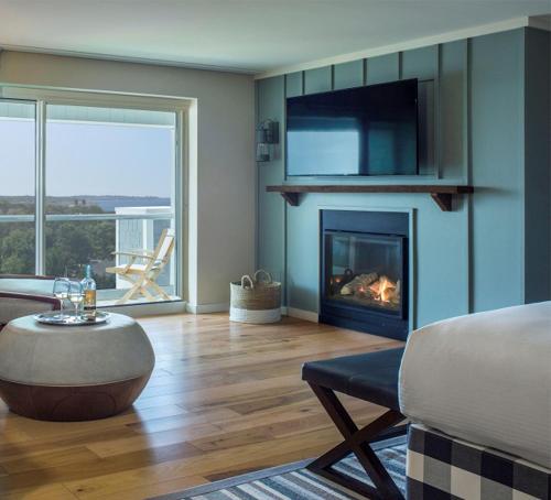 a living room with a couch and a fireplace at Cliff House Maine in Cape Neddick