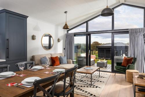 a living room with a table and a couch at Retallack Resort by Away Resorts in Padstow