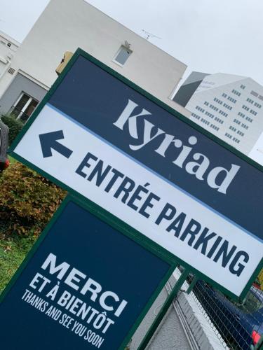 a blue and white street sign in front of a building at Kyriad Lille Gare - Grand Palais in Lille