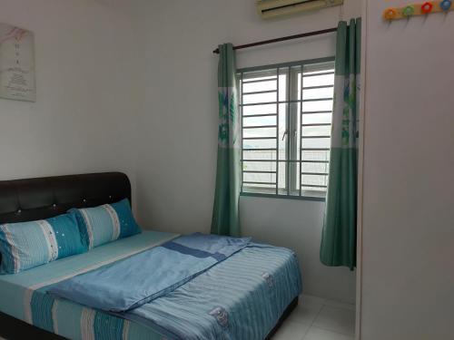 a bedroom with a bed and a window with green curtains at Lake Residence No165 @aesthetic lake view & best photograph in Puchong