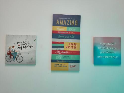 three books on a wall with a person riding a bike at Lake Residence No165 @aesthetic lake view & best photograph in Puchong