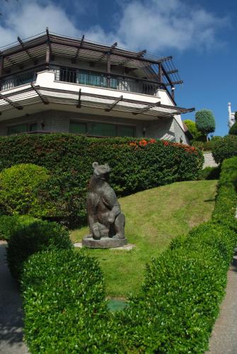 a statue of a bear sitting in front of a building at Art Complex Anel in Sozopol