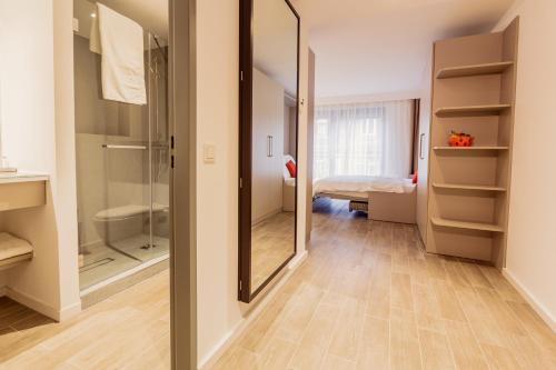 a bathroom with a walk in shower and a mirror at 360 Degree Apartment in Frankfurt