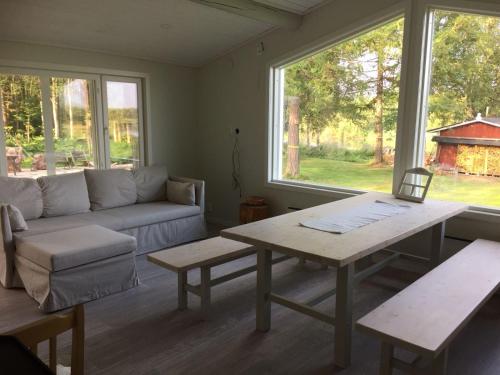 a living room with a couch and a table at Villa Saagala by Tornio River in Tornio