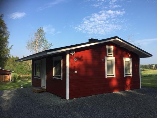 a red cabin with a black roof at Villa Saagala by Tornio River in Tornio