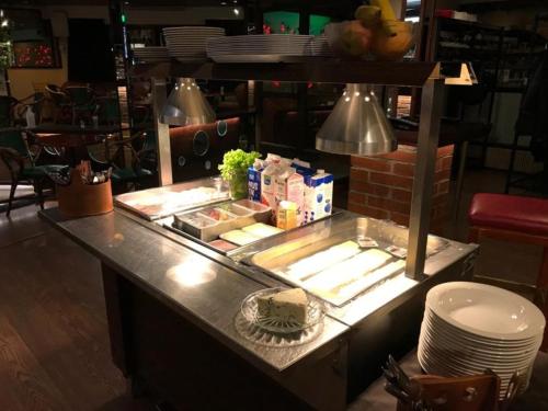 a counter in a restaurant with some food on it at Hotel Carneval in Suonenjoki