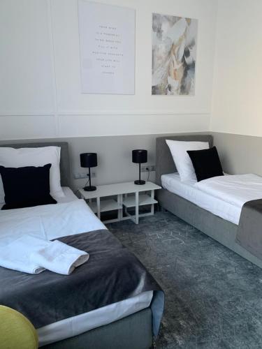 two beds sitting next to each other in a room at Hotel Coliber in Kłobuck