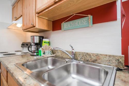 a kitchen sink with aethrise sign above it at Captain’s Quarters at Anna Maria Island Inn in Bradenton Beach