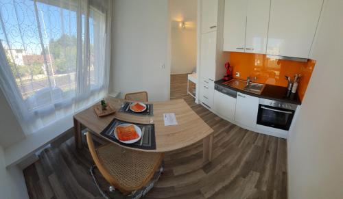 a kitchen with a table and chairs and a sink at HSH Solothurn - Junior Suite LEHN Apartment in Oensingen by HSH Hotel Serviced Home in Oensingen