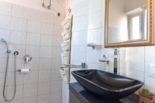 a bathroom with a black sink and a mirror at Pigneto Life Nest in Rome